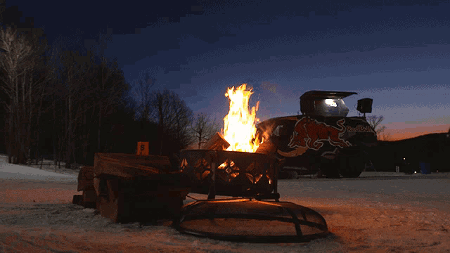 a red bull atv is lit up in the snow