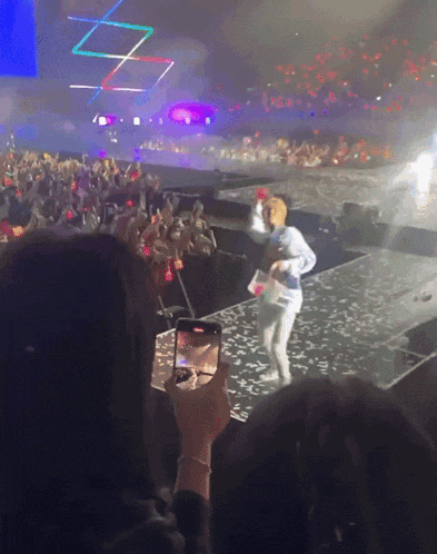 a person is taking a picture of a person on stage