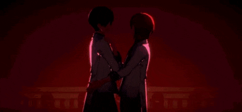 a boy and a girl are kissing each other in front of a red heart .
