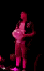 a blurry picture of a man in a floral shirt dancing in the dark .