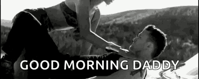 a black and white photo of a man and a woman laying on top of each other .