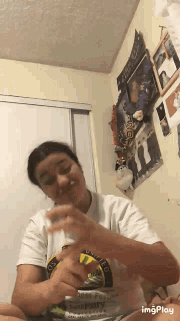 a girl wearing a white shirt that says ' los angeles ' on the front