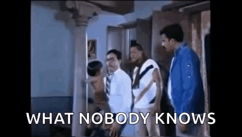 a group of men are standing in a room with the words `` what nobody knows '' written on the screen .