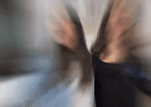 a blurry picture of a person 's torso with a white shirt being pulled up