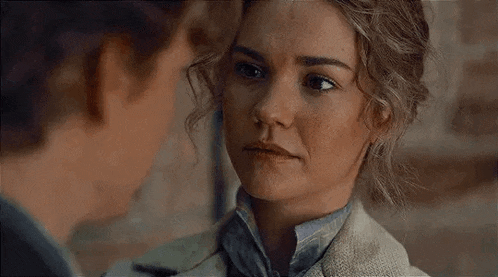 a man and a woman are looking at each other . the woman is looking at the man 's face .