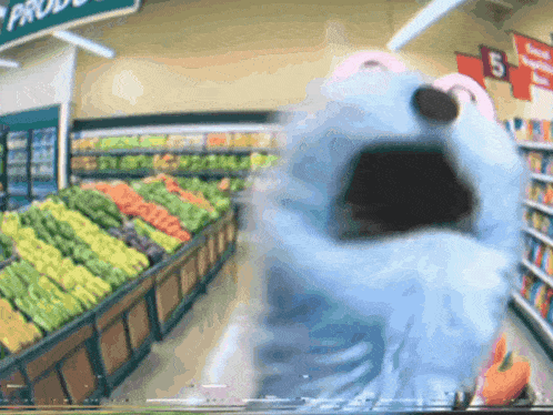 a blurry picture of a grocery store with a sign that says produce on it