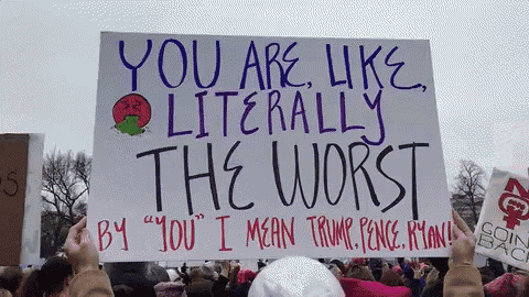 a protester holds up a sign that says you are like literally the worst