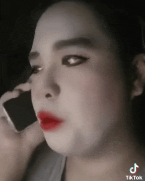 a close up of a woman talking on a cell phone with tiktok written on the bottom right