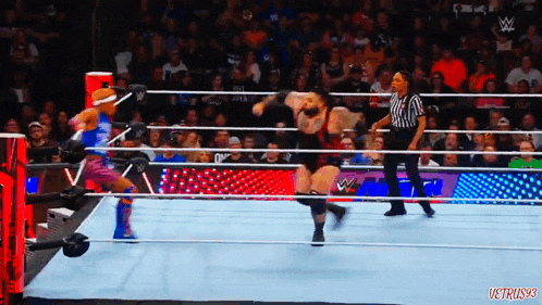wrestlers in a wrestling ring with a referee and a sign that says ' vctrus93 ' on it