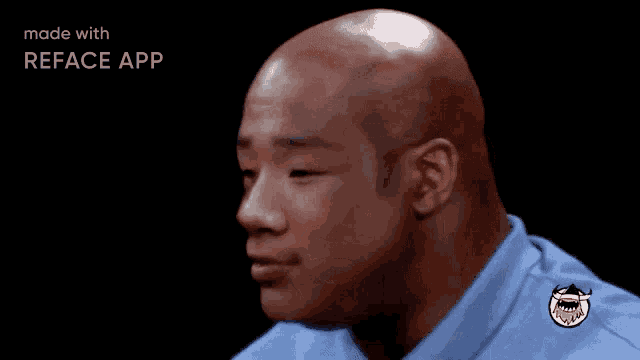 a bald man in a blue shirt with the words nbanicks is typing below him