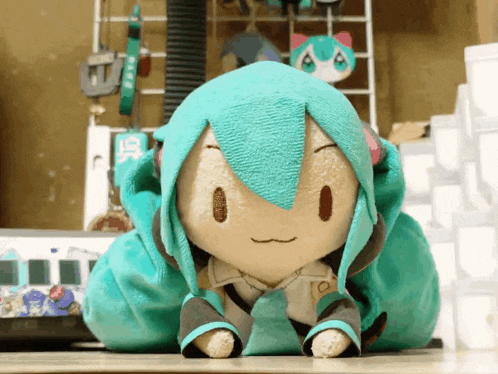 a stuffed hatsune miku sitting on a table