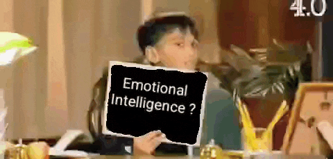 a boy is holding a sign that says emotional intelligence ?