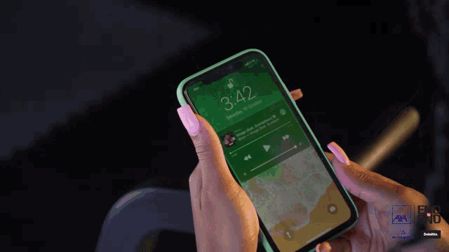 a person is holding a cell phone with the time 3:42 on the screen