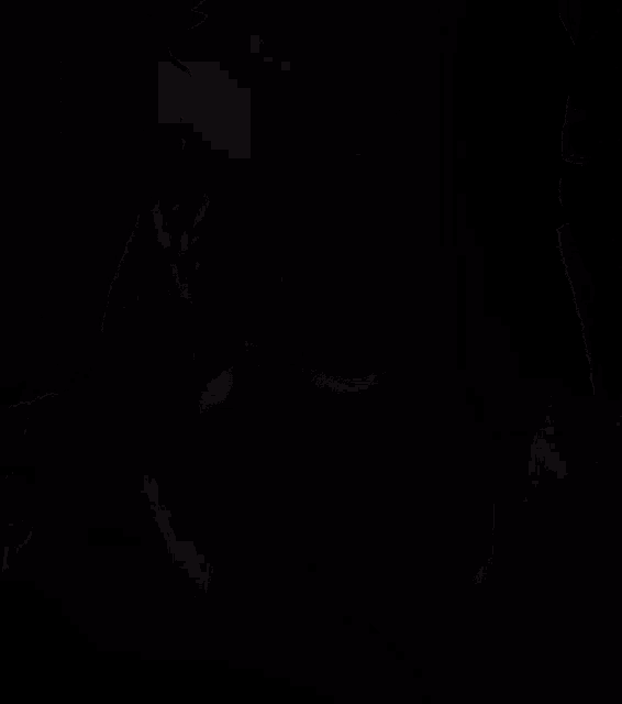 a blurred image of a person 's face in a dark room
