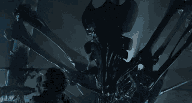 a person is being attacked by a giant alien