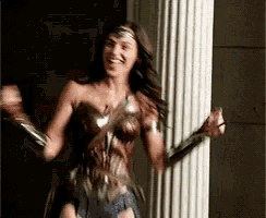 a woman in a wonder woman costume is standing in front of a pillar .