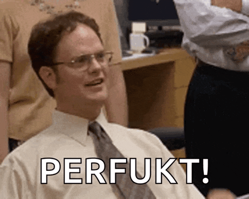 a man in a white shirt and tie is smiling and says perfukt !