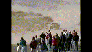 a group of people standing in front of a car in the desert
