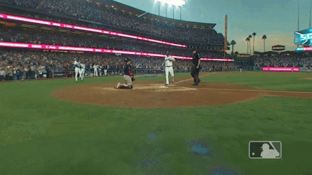 a baseball game is being played in a stadium with a scoreboard