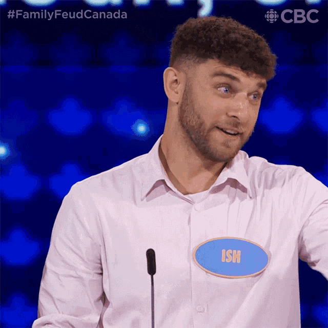 a man in a pink shirt has a name tag that says ish on it