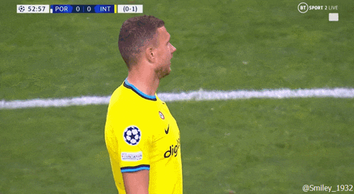 a soccer player wearing a yellow shirt that says digital