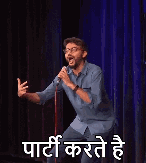 a man is standing on a stage holding a microphone and making a funny face while speaking into it .