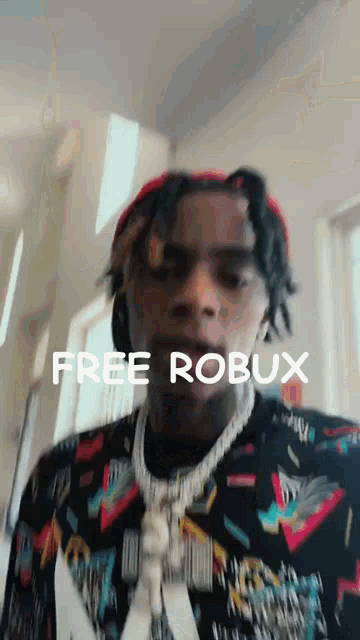a man with dreadlocks is wearing a red hat and a sweater that says free robux on it .