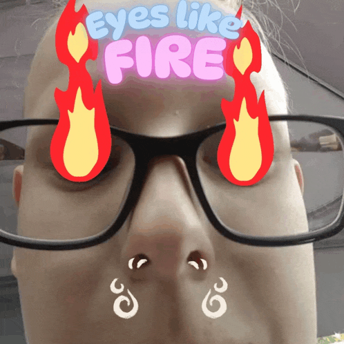 a woman wearing glasses has flames on her face and the words eyes like fire above her