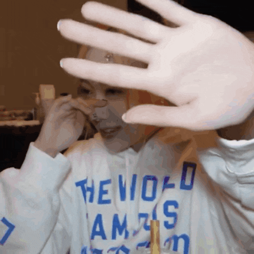 a person wearing a hoodie that says the world