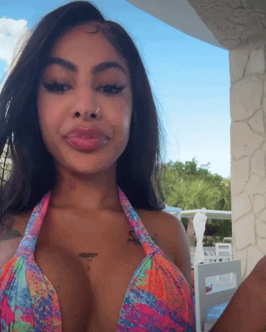 a woman in a bikini with a tattoo on her chest that says ' i love you '