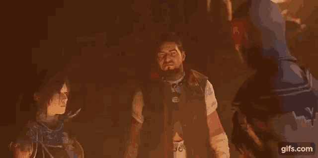 a man and a woman are standing next to each other in a dark room in a video game .