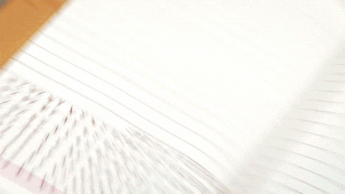 a person 's hand is reaching into a notebook with a pen