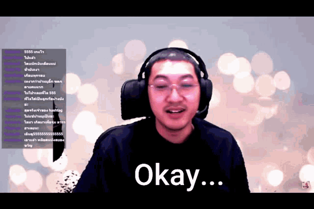 a man wearing headphones says okay in front of a blurred background