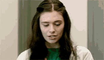 a close up of a woman 's face with her eyes closed .