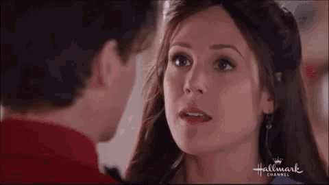 a man and a woman are looking at each other in a hallmark channel ad .