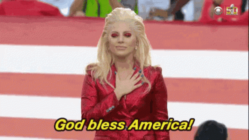 a woman in a red suit is holding her hand to her chest and says god bless america .