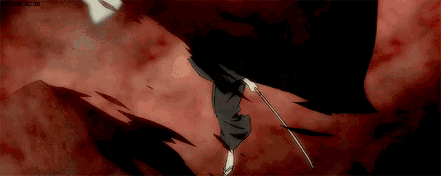 a person is holding a sword in their hand in a dark room ..