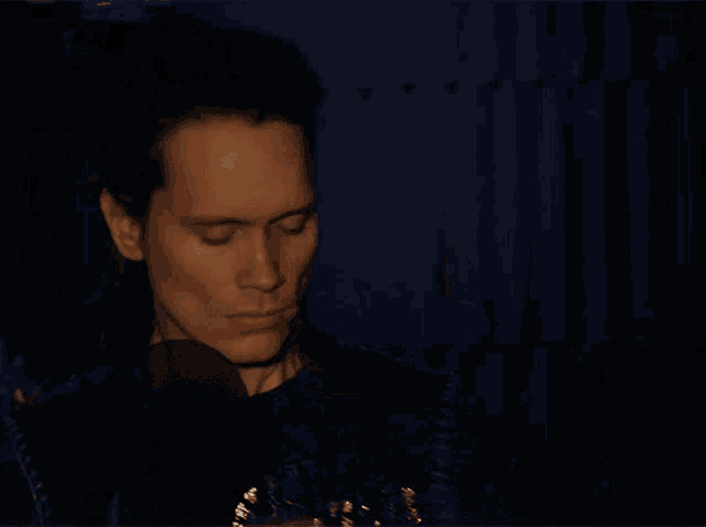 a blurry picture of a man 's face with a blue background