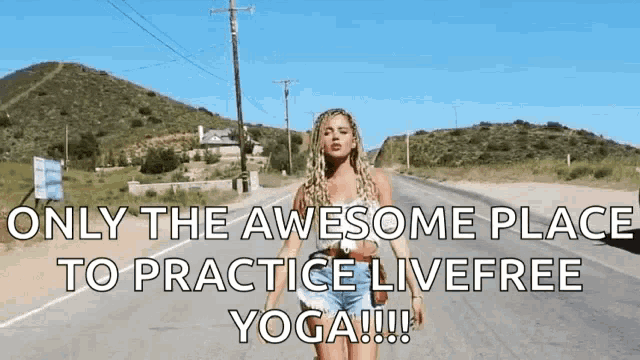 a woman is standing on the side of a road with the words only the awesome place to practice live free yoga
