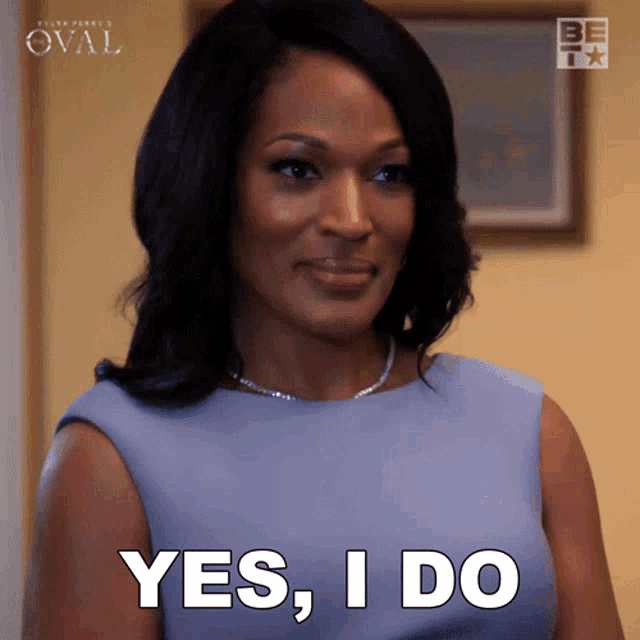 a woman in a blue dress says yes i do in white letters