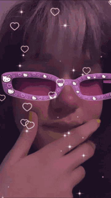 a person wearing purple hello kitty sunglasses with hearts and stars around them