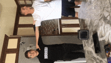 two boys standing next to each other with one wearing a sweater that says hypnosis on it