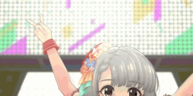 a girl with a flower in her hair is giving a peace sign .