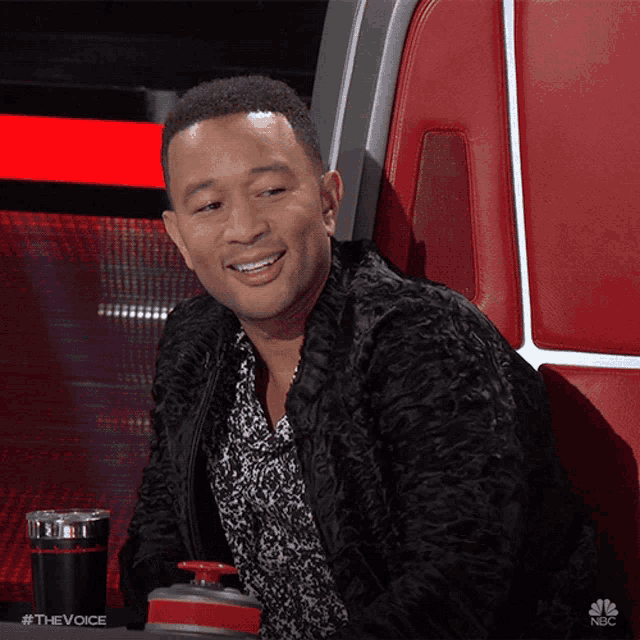 a man sitting in a chair with a nbc logo on the bottom right