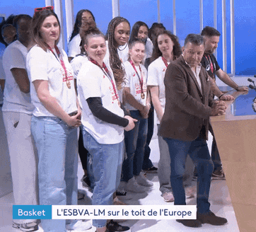 a group of people standing next to each other with a sign that says basket