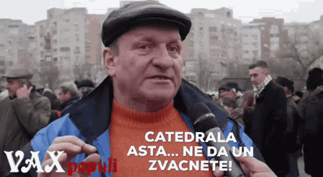 a man is talking into a microphone with the words catedrala asta ne da un zvacnete