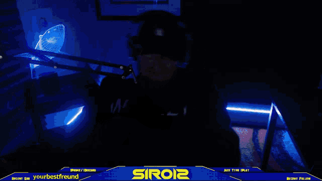 a man playing a guitar in a dark room with a blue banner that says siroi2