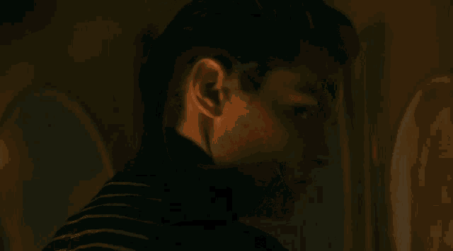 a close up of a man 's face looking at the camera