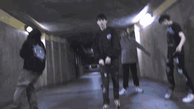 a blurry picture of a group of people walking down a hallway .