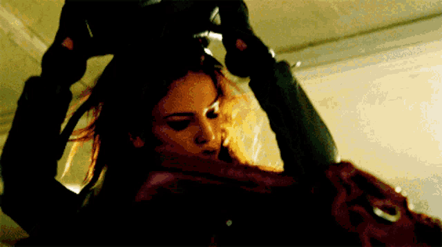 a close up of a woman 's face with a glove on
